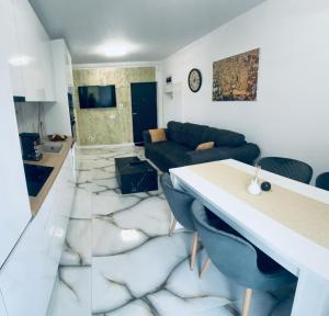 a living room with a couch and a table at Golden Apartament in Şelimbăr