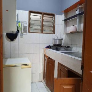 a kitchen with a sink and a stove in it at Appartement 2 Chambre Salon à Abomey-Calavi Bakita in Abomey-Calavi
