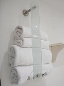 a bunch of towels are on a rack in a bathroom at Ferienhof Landlord in Fehmarn