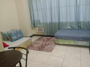 a small room with a bed and a couch at JY7 Room Rentals Cebu in Cebu City +59 photos