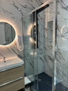 a bathroom with a shower and a sink at La Ferme Des Barmonts in Villejuif +115 photos
