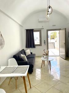 a living room with a couch and a table at AK Suites in Imerovigli