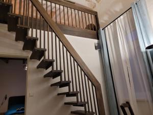 a staircase with wooden railings in a house at Hafen Deern in Flensburg