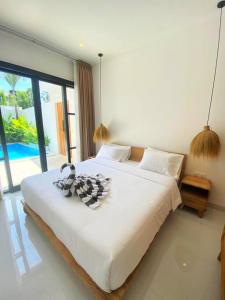 Ένα ή περισσότερα κρεβάτια σε δωμάτιο στο Cosy 2bed/2bath villa 5 min to beach