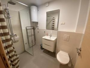 a bathroom with a toilet and a sink and a shower at Apartmani Spaija in Kaštela +56 photos