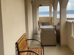 a balcony with benches and a view of the ocean at Apartmani Spaija in Kaštela