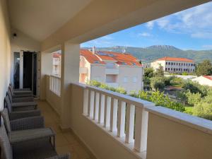 a balcony with stairs and a view of a city at Apartmani Spaija in Kaštela