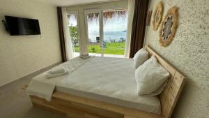 a bedroom with a bed with a view of the ocean at The Roof Ada in Adalar