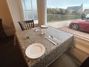 uma mesa com um prato com uma janela em Harbour lights guesthouse em Weymouth