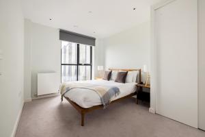 a white bedroom with a bed and a window at Charles Hope London Croydon in Croydon +55 photos