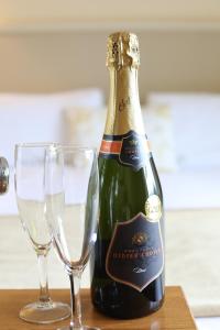 a bottle of champagne and two glasses on a table at Killeen House Hotel in Killarney