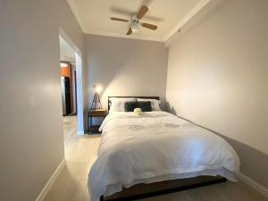 a bedroom with a bed with a ceiling fan at LLT Richard in Vancouver