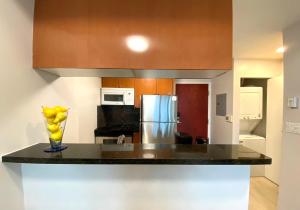 a kitchen with a counter with a vase of bananas on it at LLT Richard in Vancouver