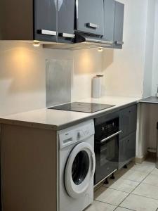 a kitchen with a washing machine and a stove at Appartement in Fort-de-France
