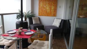 a dining room with a red table and chairs at CasaHotel El Tambo Huancayo in Huancayo