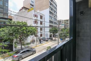 a view from a window of a street with a car at One By Wynwood House in Lima