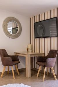 a dining room table with two chairs and a mirror at Split Old Town Apartment in Split