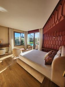 a bedroom with a large bed and a large window at Villa familiale 5 chambres in Marrakech