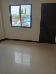 a white room with a window and a door at THE TAJ Inn in Cagayan de Oro