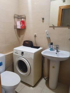 a bathroom with a washing machine and a sink at Guest House Tbilisi style in Tbilisi City