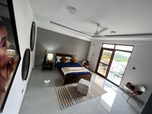 a bedroom with a bed and a large window at Penthouse Living in Mombasa