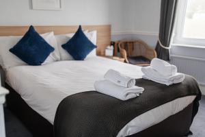 - une chambre avec un lit et des serviettes dans l'établissement The Elizabeth, à Sidmouth