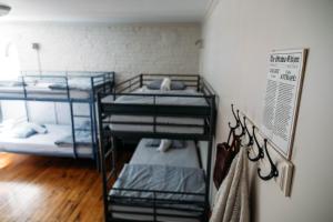 a room with three bunk beds in it at Saintlo Ottawa Jail Hostel in Ottawa