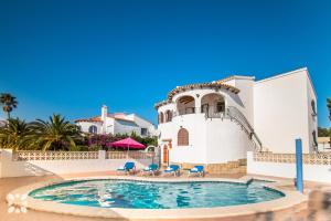 a villa with a swimming pool in front of a house at Villa Rachelle by Abahana Villas in Calpe