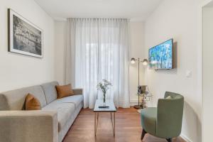 a living room with a couch and a table at Waldstätterhof Swiss Quality Hotel in Luzern