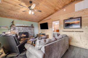 a living room with a couch and a fireplace at Cozy Cabin in Sugar Mountain