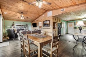 a dining room with a wooden table and chairs at Cozy Cabin in Sugar Mountain