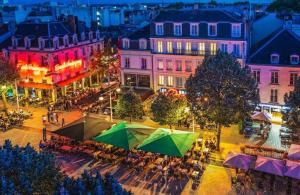 an overhead view of a city at night at Les Rives Rémoises in Reims