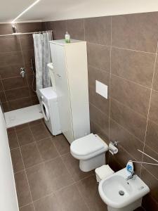 a small bathroom with a toilet and a sink at Holiday House in Palermo