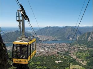 a gondola ride over a city on a mountain at La casa di Ale in Lecco