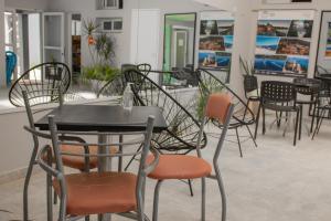 a group of tables and chairs in a restaurant at Apart del Golfo in Las Grutas