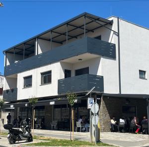 a building with a motorcycle parked in front of it at Apartman Sandra in Nova Gradiška