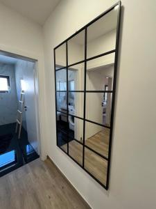 a large mirror on a wall in a room at Apartman Sandra in Nova Gradiška