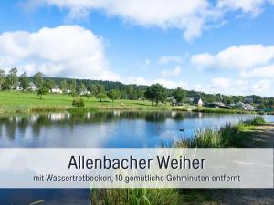 a view of a lake with the words alanderiteriteriter inhibitor inhibitor min at Villa Heimat am Nationalpark in Allenbach