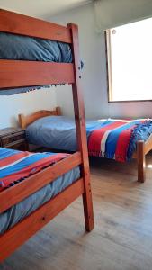 two bunk beds in a room with a window at Casa en Farellones in Santiago