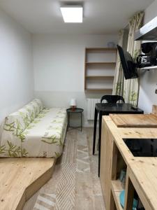 a small room with a bed and a desk at Au coeur de Bordeaux in Bordeaux