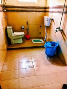 a bathroom with a toilet and a bucket at Lashari Resort in Skardu