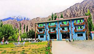 a blue building with chairs and mountains in the background at Lashari Resort in Skardu