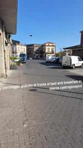 a street with a parking lot with cars parked at Casa Holiday Sea Etna Di Enza in Linguaglossa