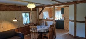 a kitchen and dining room with a table and chairs at Waltersdorfer Häusl in Waltersdorf