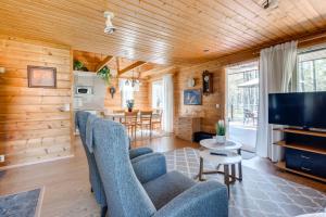ein Wohnzimmer mit blauen Stühlen und einem TV in der Unterkunft Mehtämökki in Kalajoki