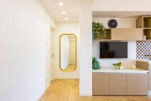 a living room with a mirror and a tv at Residence Panoramic in Maiori +37 photos