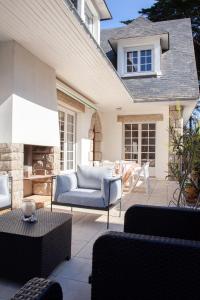 une terrasse avec un canapé, une table et des chaises dans l'établissement Villa Topaze La Baule les Pins, à La Baule