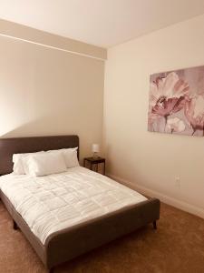 a bedroom with a bed and a painting on the wall at Penn Street Tower in Indianapolis