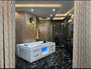 a bathroom with a bath tub in a room at Luxury Penthouse Bahria Town in Lahore