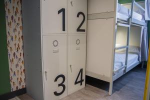 a room with two bunk beds with numbers on it at room00 Valencia Hostel in Valencia